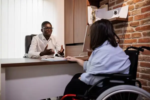 Paralysis injury lawyer meeting with paralyzed client to discuss legal case